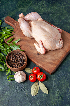 front view fresh raw chicken with tomatoes on dark-blue background kitchen restaurant meal animal photo farm meat color food chicken